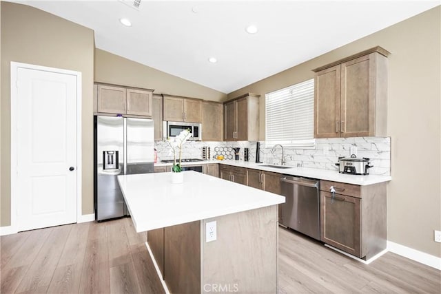 27741 Solitude Ave, Moreno Valley, CA 92555 - kitchen featuring appliances with stainless steel finishes, backsplash, vaulted ceiling, light wood-type flooring, and recessed lighting