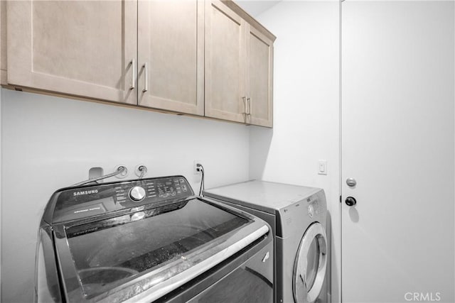 27741 Solitude Ave, Moreno Valley, CA 92555 - washroom with independent washer and dryer and cabinet space