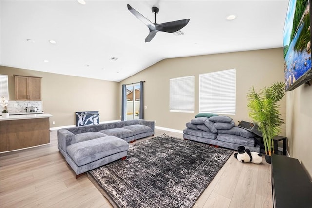 27741 Solitude Ave, Moreno Valley, CA 92555 - living area with a ceiling fan, light wood finished floors, vaulted ceiling, recessed lighting, and plenty of natural light