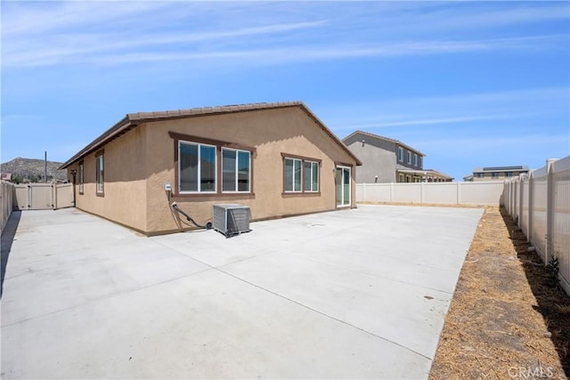 27741 Solitude Ave, Moreno Valley, CA 92555 - rear view of property with a patio, a fenced backyard, and stucco siding