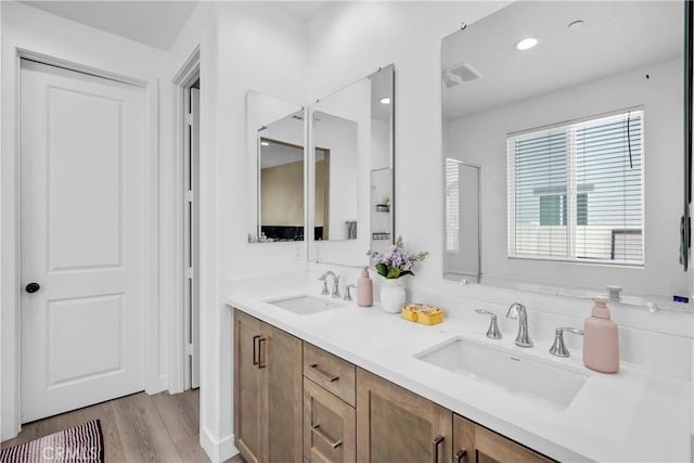 27741 Solitude Ave, Moreno Valley, CA 92555 - bathroom featuring double vanity, wood finished floors, and recessed lighting