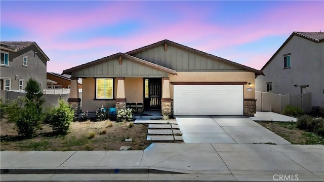 27741 Solitude Ave, Moreno Valley, CA 92555 - view of front of house with covered porch, stucco siding, an attached garage, and stone siding