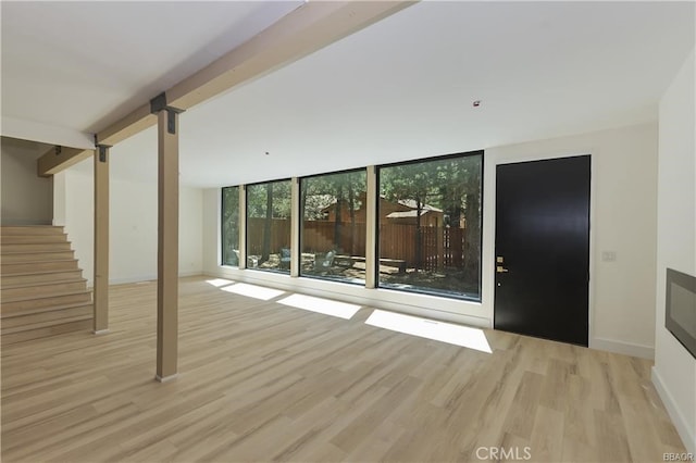 216 Leonard Ln, Big Bear, CA 92386 - unfurnished living room with wood finished floors, stairs, floor to ceiling windows, and a barn door