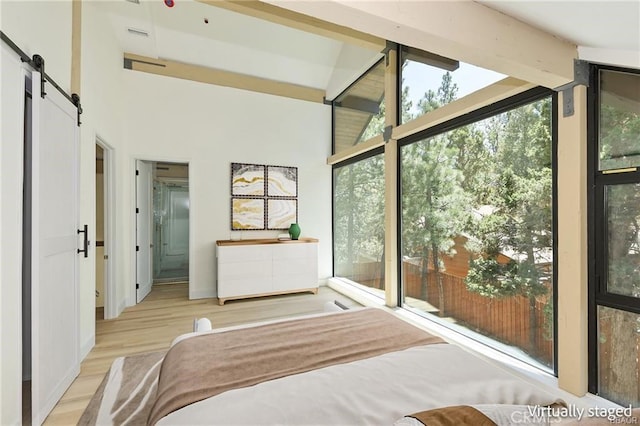 216 Leonard Ln, Big Bear, CA 92386 - bedroom featuring a barn door, wood finished floors, and ensuite bathroom