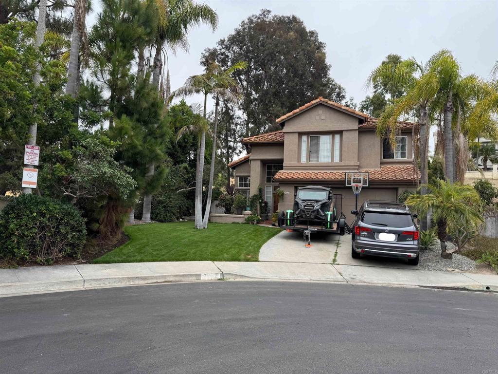 7000 Via Padilla, Carlsbad, CA 92009 - mediterranean / spanish house with concrete driveway, a tile roof, an attached garage, stucco siding, and a front yard