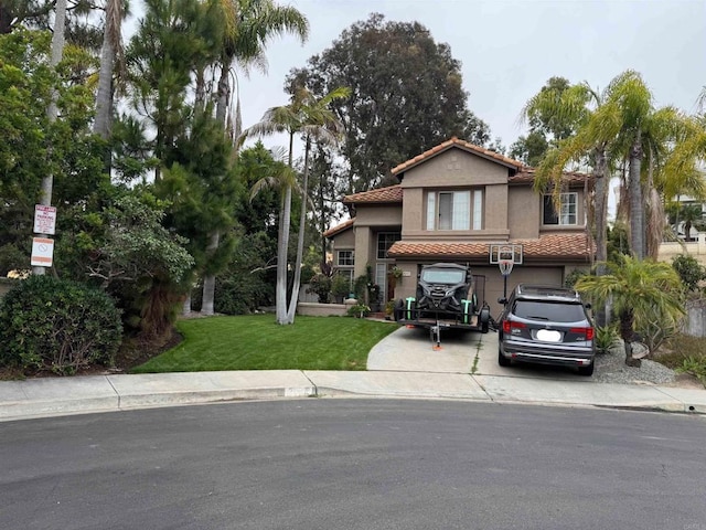 7000 Via Padilla, Carlsbad, CA 92009 - mediterranean / spanish house with concrete driveway, a tile roof, an attached garage, stucco siding, and a front yard