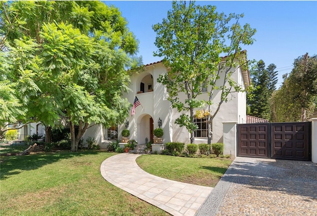 1811 N Flower St, Santa Ana, CA 92706 - mediterranean / spanish home with stucco siding, a front lawn, driveway, and a garage