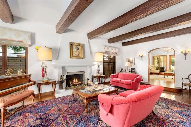 1811 N Flower St, Santa Ana, CA 92706 - living room with plenty of natural light, hardwood / wood-style flooring, a warm lit fireplace, and beamed ceiling
