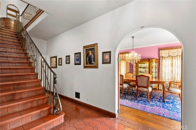 1811 N Flower St, Santa Ana, CA 92706 - stairway featuring arched walkways, a chandelier, and tile patterned flooring