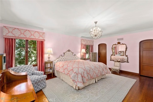 1811 N Flower St, Santa Ana, CA 92706 - bedroom featuring arched walkways, multiple windows, a chandelier, wood finished floors, and crown molding