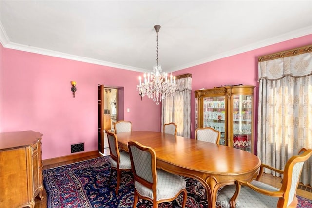 1811 N Flower St, Santa Ana, CA 92706 - dining room featuring a chandelier, crown molding, and wood finished floors