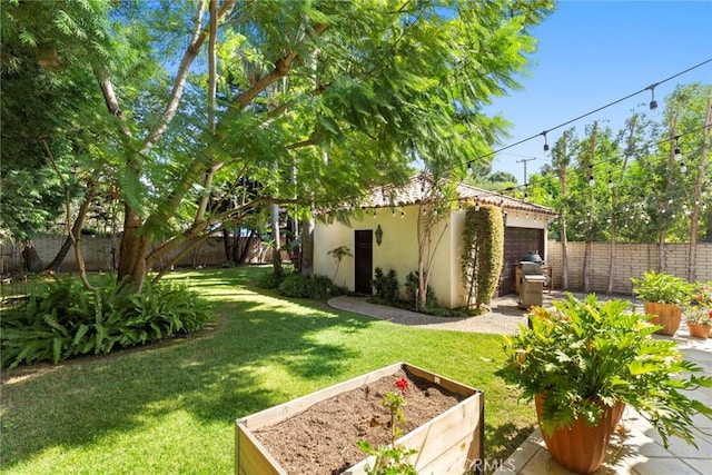 1811 N Flower St, Santa Ana, CA 92706 - fenced backyard with a vegetable garden and an outbuilding