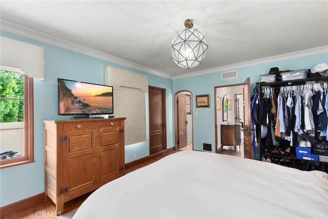1811 N Flower St, Santa Ana, CA 92706 - bedroom featuring wood finished floors, crown molding, and arched walkways