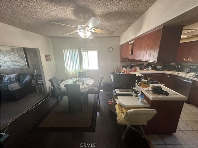 1409 E 41st Pl, Los Angeles, CA 90011 - dining space with light tile patterned floors, a ceiling fan, and a textured ceiling