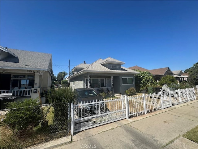 1409 E 41st Pl, Los Angeles, CA 90011 - bungalow-style house with a fenced front yard, a gate, and stucco siding