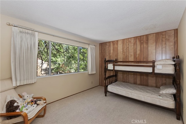 325 Brentwood, Lake Arrowhead, CA 92352 - bedroom featuring carpet flooring, wood walls, and a textured ceiling