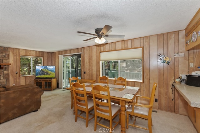 325 Brentwood, Lake Arrowhead, CA 92352 - dining room featuring light colored carpet, a textured ceiling, wood walls, and a ceiling fan
