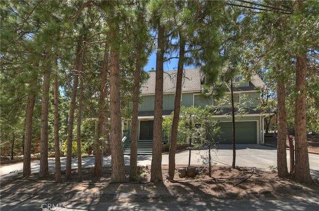 325 Brentwood, Lake Arrowhead, CA 92352 - view of front of house featuring driveway, roof with shingles, and a garage