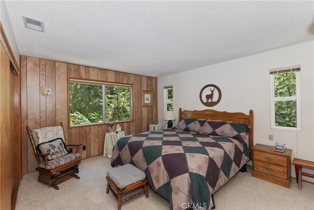325 Brentwood, Lake Arrowhead, CA 92352 - bedroom with carpet, a textured ceiling, and wood walls