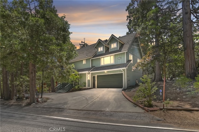 325 Brentwood, Lake Arrowhead, CA 92352 - view of front of house with driveway, an attached garage, roof with shingles, and stairs