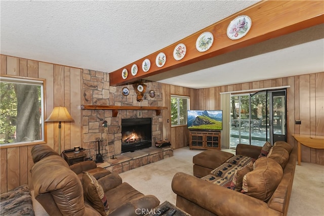 325 Brentwood, Lake Arrowhead, CA 92352 - living room with carpet floors, wood walls, a stone fireplace, and a textured ceiling