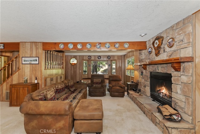 325 Brentwood, Lake Arrowhead, CA 92352 - living room with carpet, a textured ceiling, stairs, wooden walls, and a fireplace