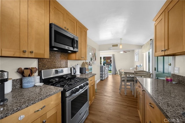 1051 Russell St, La Habra, CA 90631 - kitchen with appliances with stainless steel finishes, backsplash, dark wood finished floors, vaulted ceiling, and ceiling fan