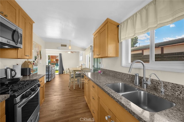 1051 Russell St, La Habra, CA 90631 - kitchen with stainless steel appliances, plenty of natural light, wood finished floors, dark stone counters, and vaulted ceiling