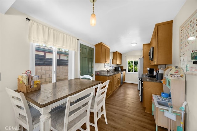 1051 Russell St, La Habra, CA 90631 - kitchen featuring dark countertops, appliances with stainless steel finishes, brown cabinets, dark wood finished floors, and lofted ceiling
