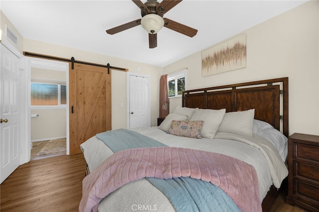 1051 Russell St, La Habra, CA 90631 - bedroom with wood finished floors, a barn door, and a ceiling fan