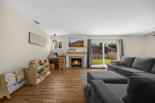 1051 Russell St, La Habra, CA 90631 - living room featuring wood finished floors, plenty of natural light, and a tile fireplace