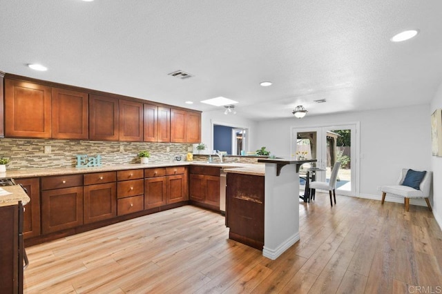 506 Broadview St, Spring Valley, CA 91977 - kitchen featuring a peninsula, light wood-style floors, tasteful backsplash, recessed lighting, and french doors