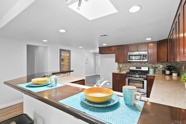 506 Broadview St, Spring Valley, CA 91977 - kitchen featuring stainless steel appliances, recessed lighting, tasteful backsplash, a skylight, and a kitchen island