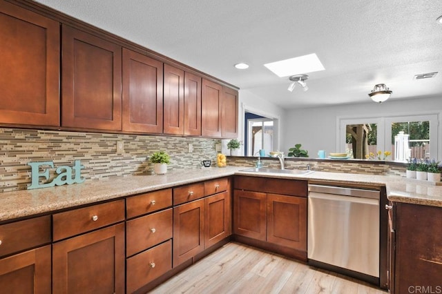 506 Broadview St, Spring Valley, CA 91977 - kitchen featuring stainless steel dishwasher, a skylight, light wood-type flooring, tasteful backsplash, and recessed lighting