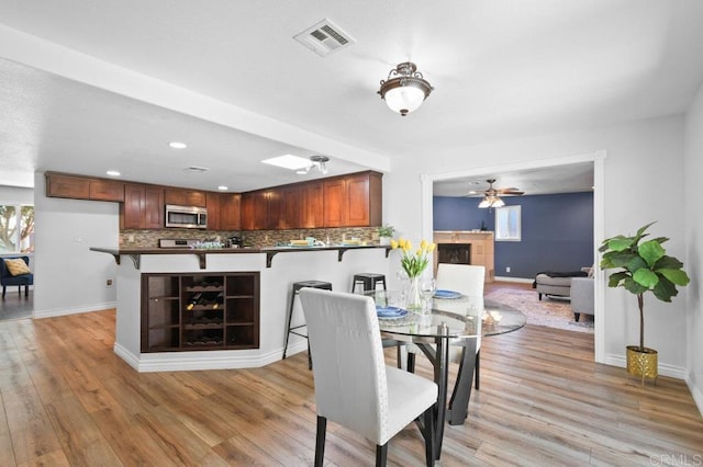 506 Broadview St, Spring Valley, CA 91977 - dining room featuring light wood-type flooring, a ceiling fan, a fireplace, and recessed lighting