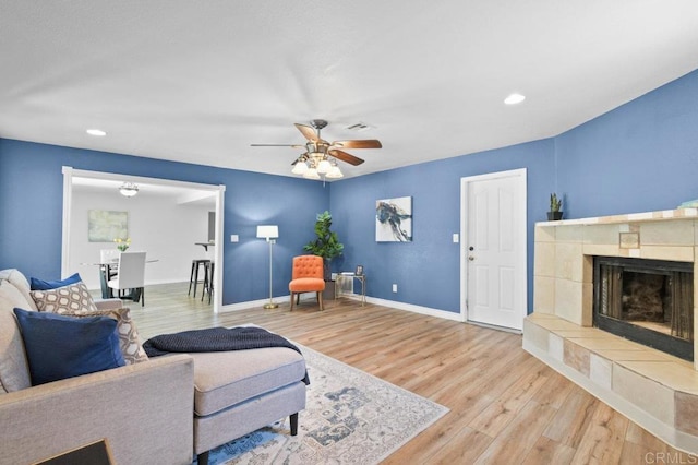 506 Broadview St, Spring Valley, CA 91977 - living room with wood finished floors, a ceiling fan, a tiled fireplace, and recessed lighting