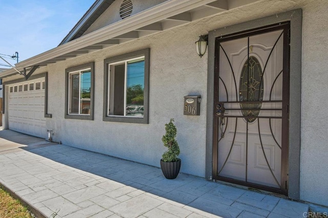 506 Broadview St, Spring Valley, CA 91977 - doorway to property with stucco siding and an attached garage