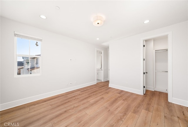 13428 Silver Sky Rd, Rancho Cucamonga, CA 91739 - unfurnished bedroom with light wood-style flooring, recessed lighting, and a walk in closet
