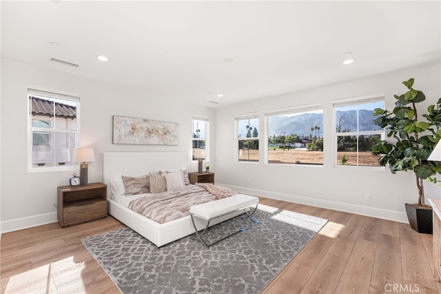 13428 Silver Sky Rd, Rancho Cucamonga, CA 91739 - bedroom with multiple windows, light wood-type flooring, a mountain view, and recessed lighting
