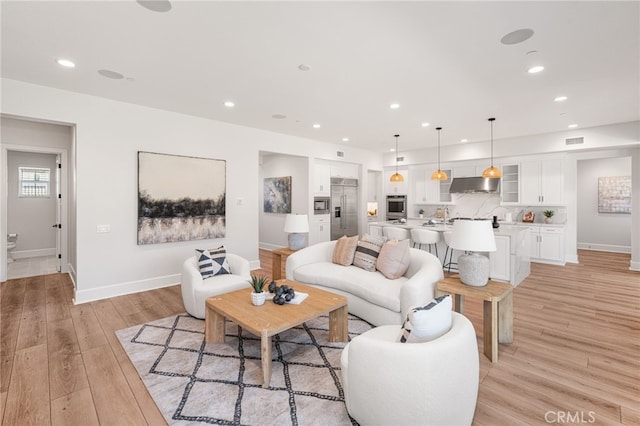 13428 Silver Sky Rd, Rancho Cucamonga, CA 91739 - living room with light wood-style flooring and recessed lighting