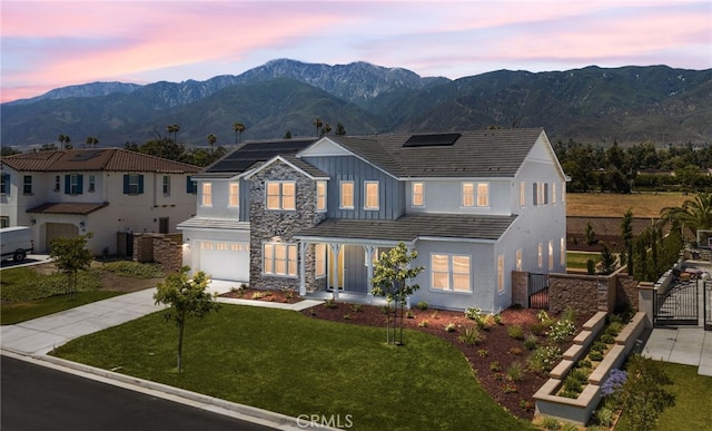 13428 Silver Sky Rd, Rancho Cucamonga, CA 91739 - view of front facade featuring concrete driveway, an attached garage, solar panels, board and batten siding, and stone siding