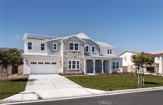 13428 Silver Sky Rd, Rancho Cucamonga, CA 91739 - view of front of house featuring board and batten siding, a garage, stone siding, driveway, and roof mounted solar panels