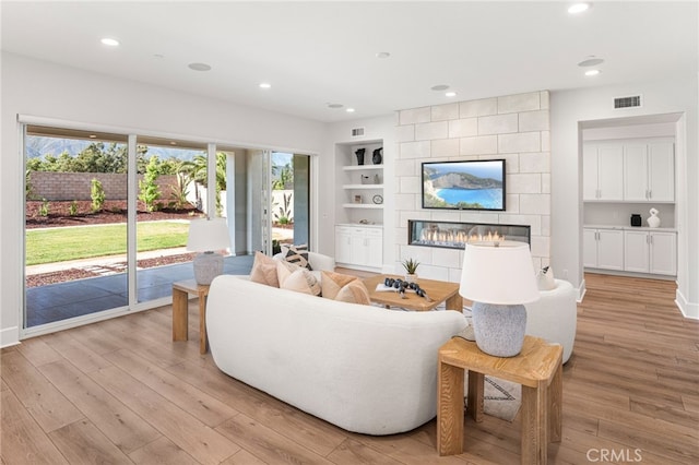 13428 Silver Sky Rd, Rancho Cucamonga, CA 91739 - living area featuring light wood-style flooring, plenty of natural light, recessed lighting, and built in shelves