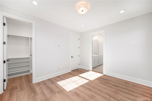 13428 Silver Sky Rd, Rancho Cucamonga, CA 91739 - unfurnished bedroom featuring a walk in closet, light wood-style flooring, connected bathroom, and recessed lighting