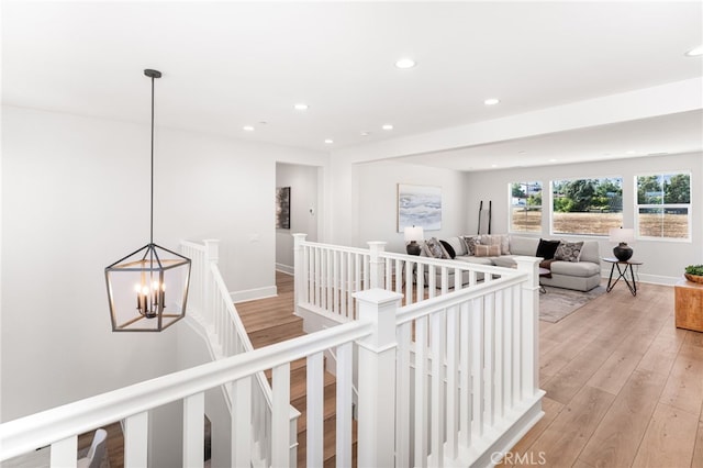 13428 Silver Sky Rd, Rancho Cucamonga, CA 91739 - hall with an upstairs landing, recessed lighting, light wood-type flooring, and a chandelier