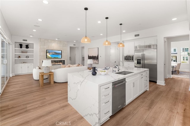 13428 Silver Sky Rd, Rancho Cucamonga, CA 91739 - kitchen featuring built in appliances, light wood finished floors, white cabinetry, and recessed lighting