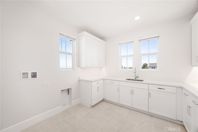 13428 Silver Sky Rd, Rancho Cucamonga, CA 91739 - laundry room featuring plenty of natural light, hookup for a washing machine, cabinet space, recessed lighting, and light tile patterned floors