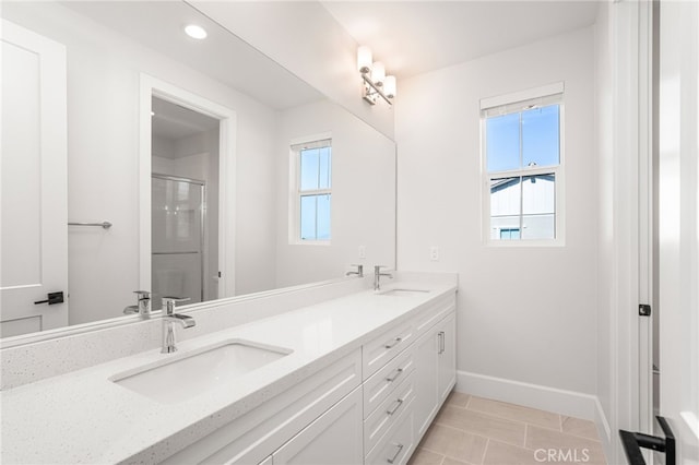 13428 Silver Sky Rd, Rancho Cucamonga, CA 91739 - full bathroom featuring healthy amount of natural light, double vanity, a shower with shower door, tile patterned floors, and recessed lighting