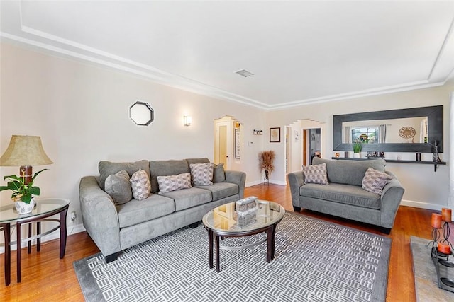 2118 W 84th St, Los Angeles, CA 90047 - living room featuring wood finished floors, arched walkways, and ornamental molding