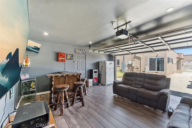 2118 W 84th St, Los Angeles, CA 90047 - living area featuring a bar, wood finished floors, and recessed lighting